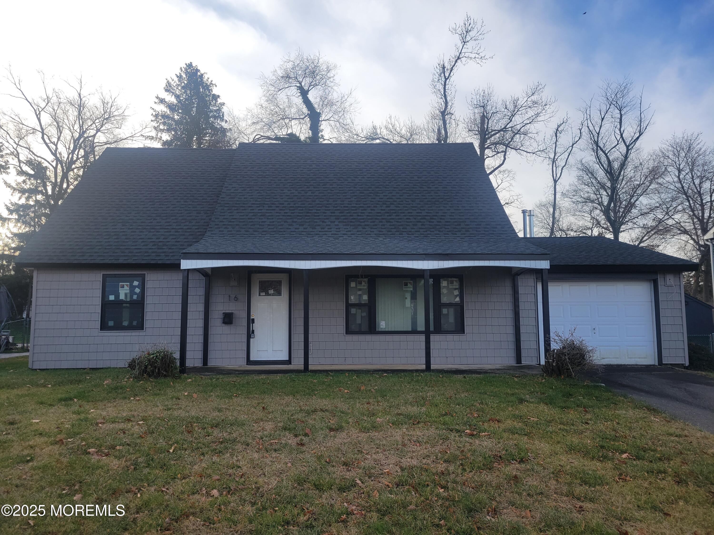 16 Fair Lane Matawan, NJ 07747 - Photo 2 of 3 a front view of a house with a garden