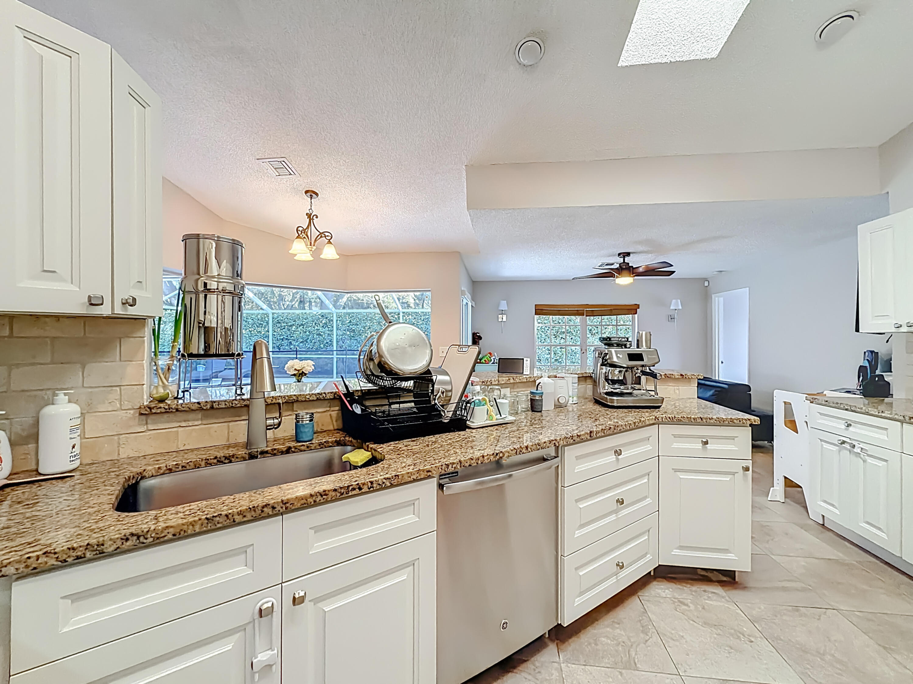 450 Northwest 53rd Street Boca Raton, FL 33487 - Photo 11 of 52 a kitchen with sink and cabinets