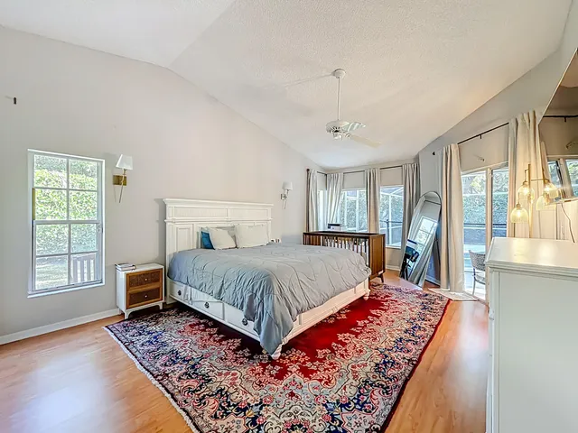 a bathroom with a granite countertop sink mirror bathtub and toilet