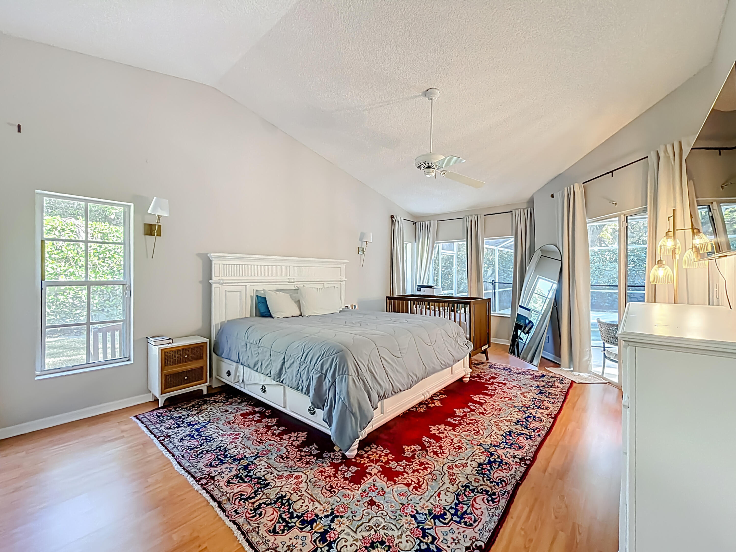 450 Northwest 53rd Street Boca Raton, FL 33487 - Photo 14 of 52 a bedroom with a bed and wooden floor