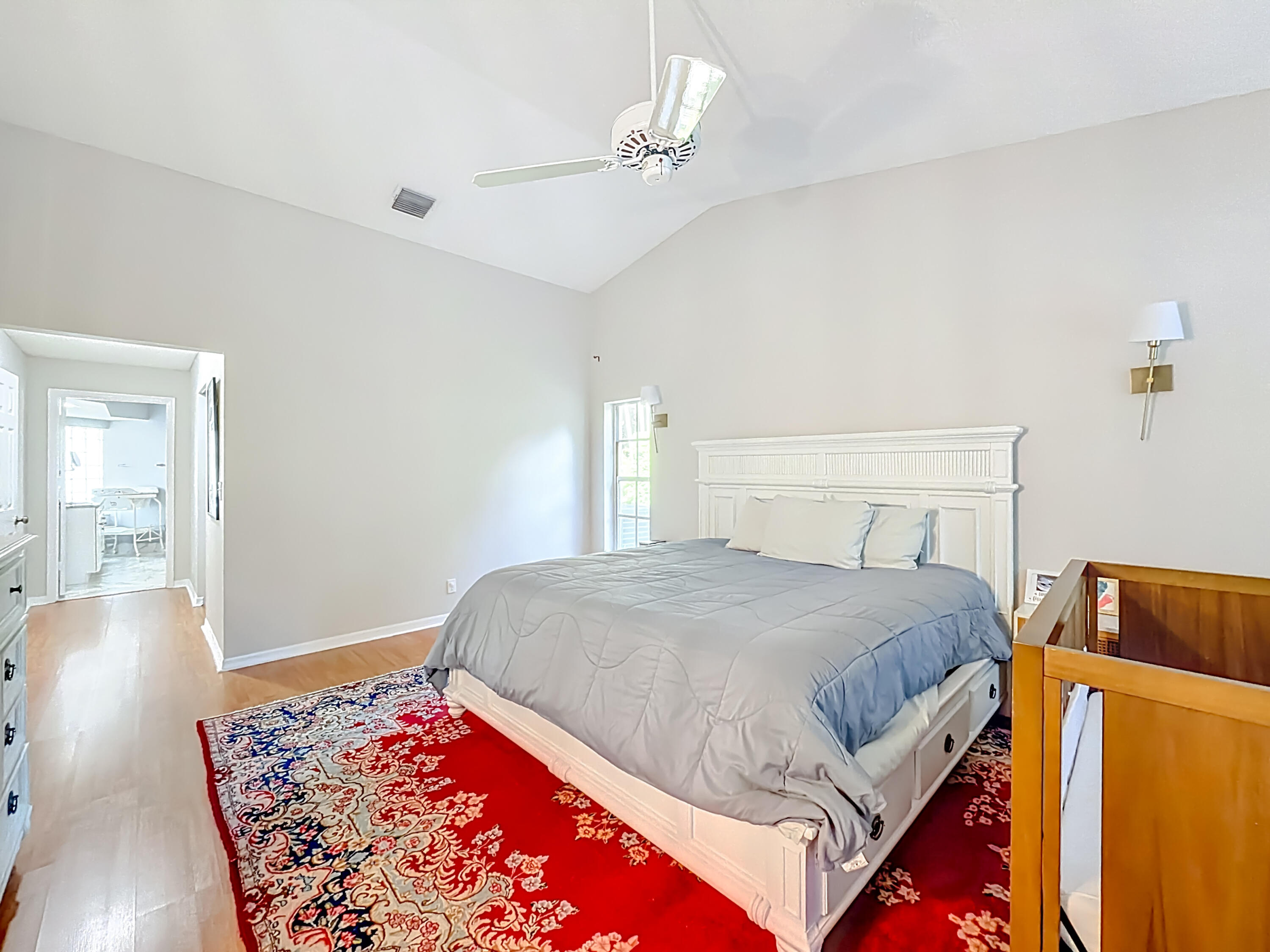 450 Northwest 53rd Street Boca Raton, FL 33487 - Photo 15 of 52 a bedroom with a bed and wooden floor