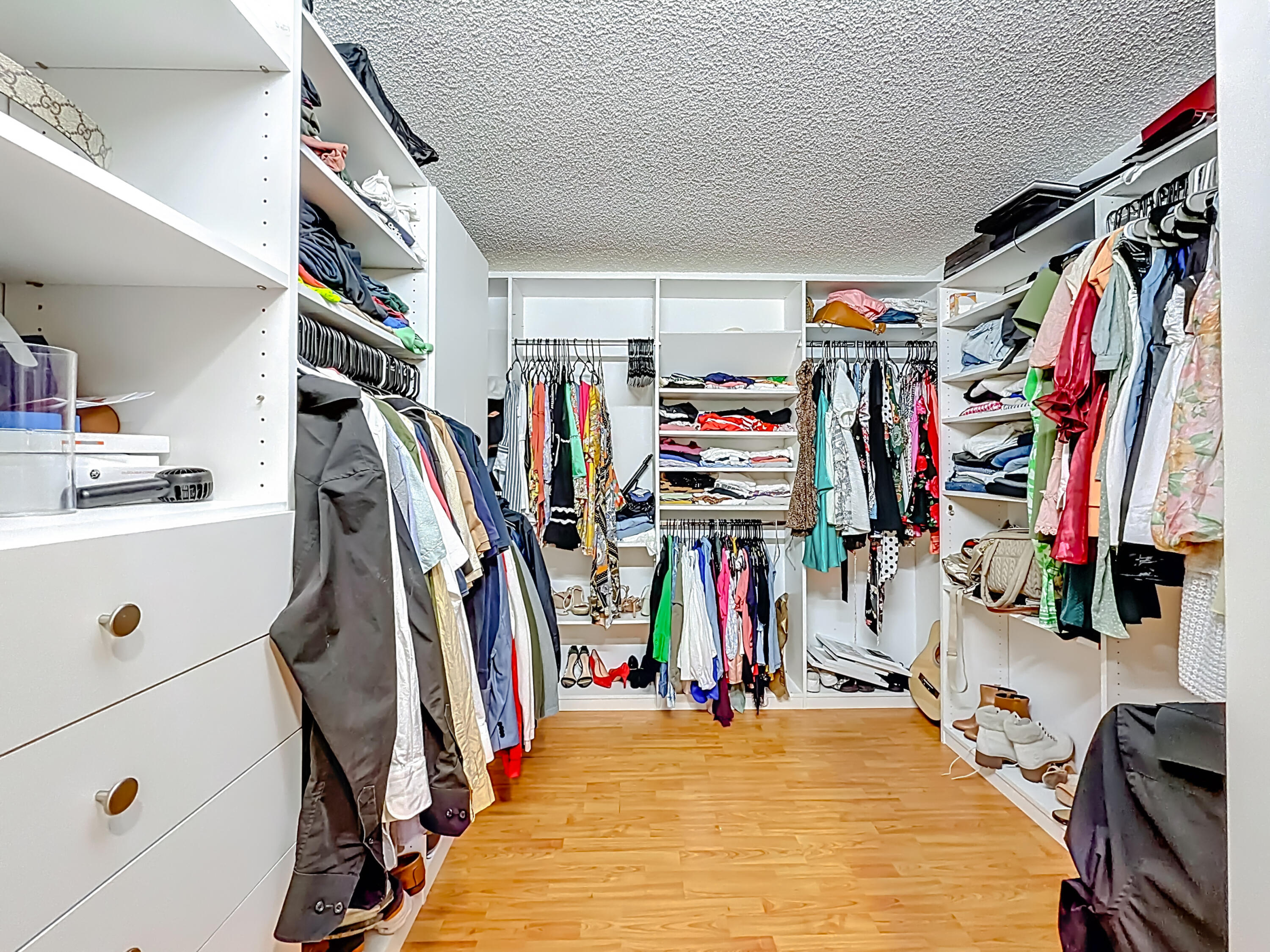 450 Northwest 53rd Street Boca Raton, FL 33487 - Photo 16 of 52 a view of walk in closet with clothes and shoes
