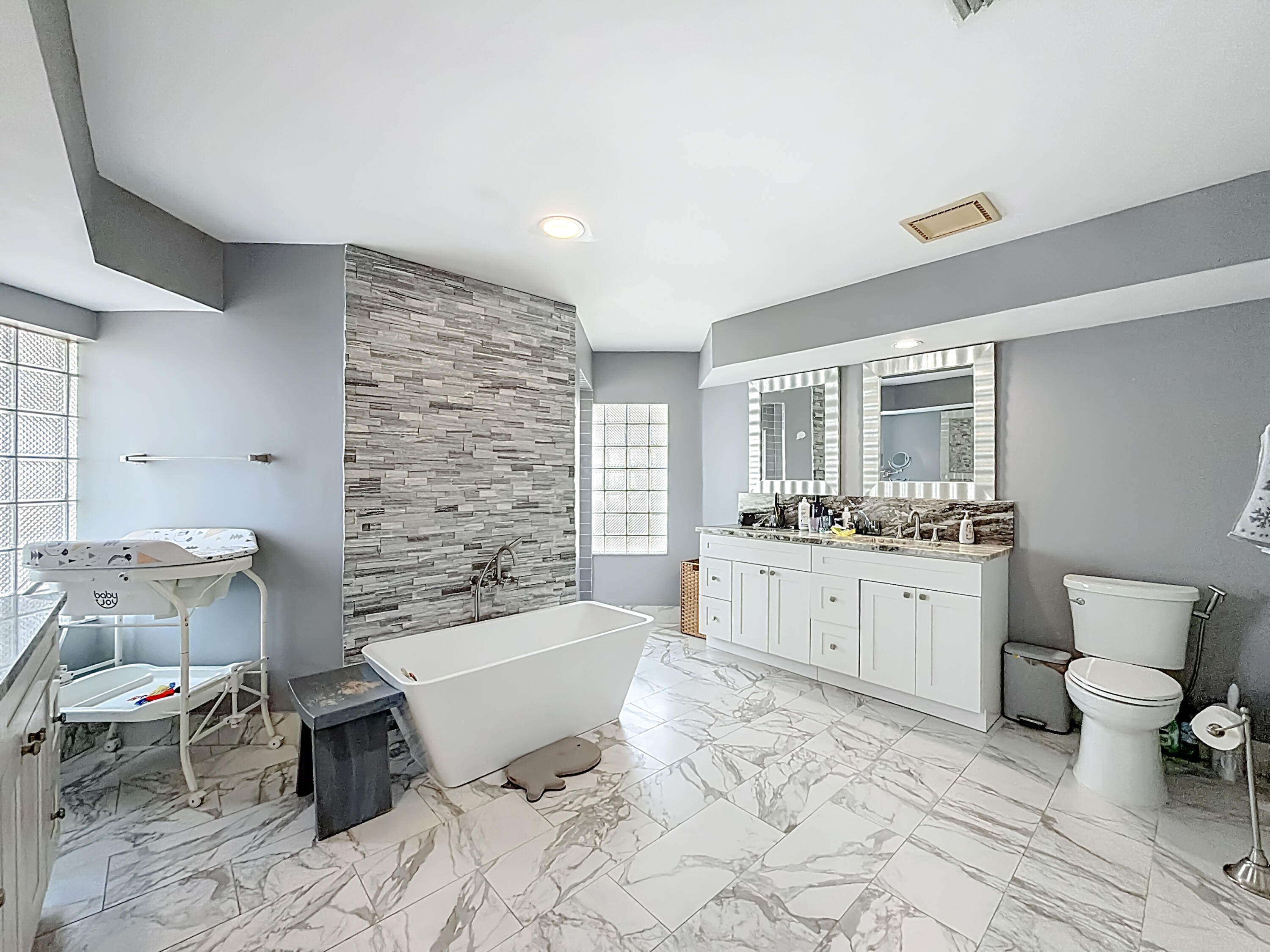 450 Northwest 53rd Street Boca Raton, FL 33487 - Photo 18 of 52 a bathroom with a granite countertop toilet a sink and bathtub
