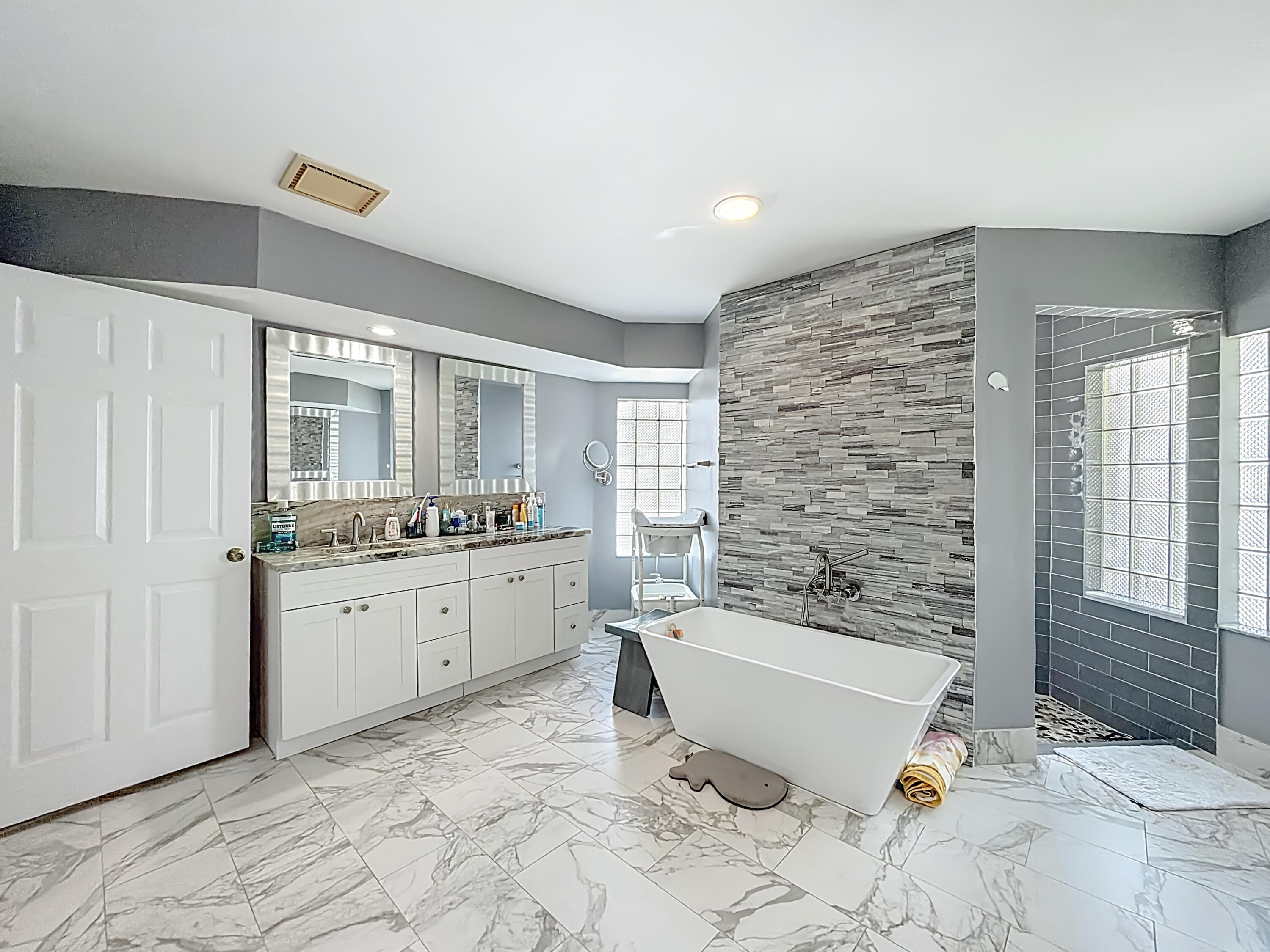 450 Northwest 53rd Street Boca Raton, FL 33487 - Photo 19 of 52 a bathroom with a granite countertop sink mirror bathtub and toilet