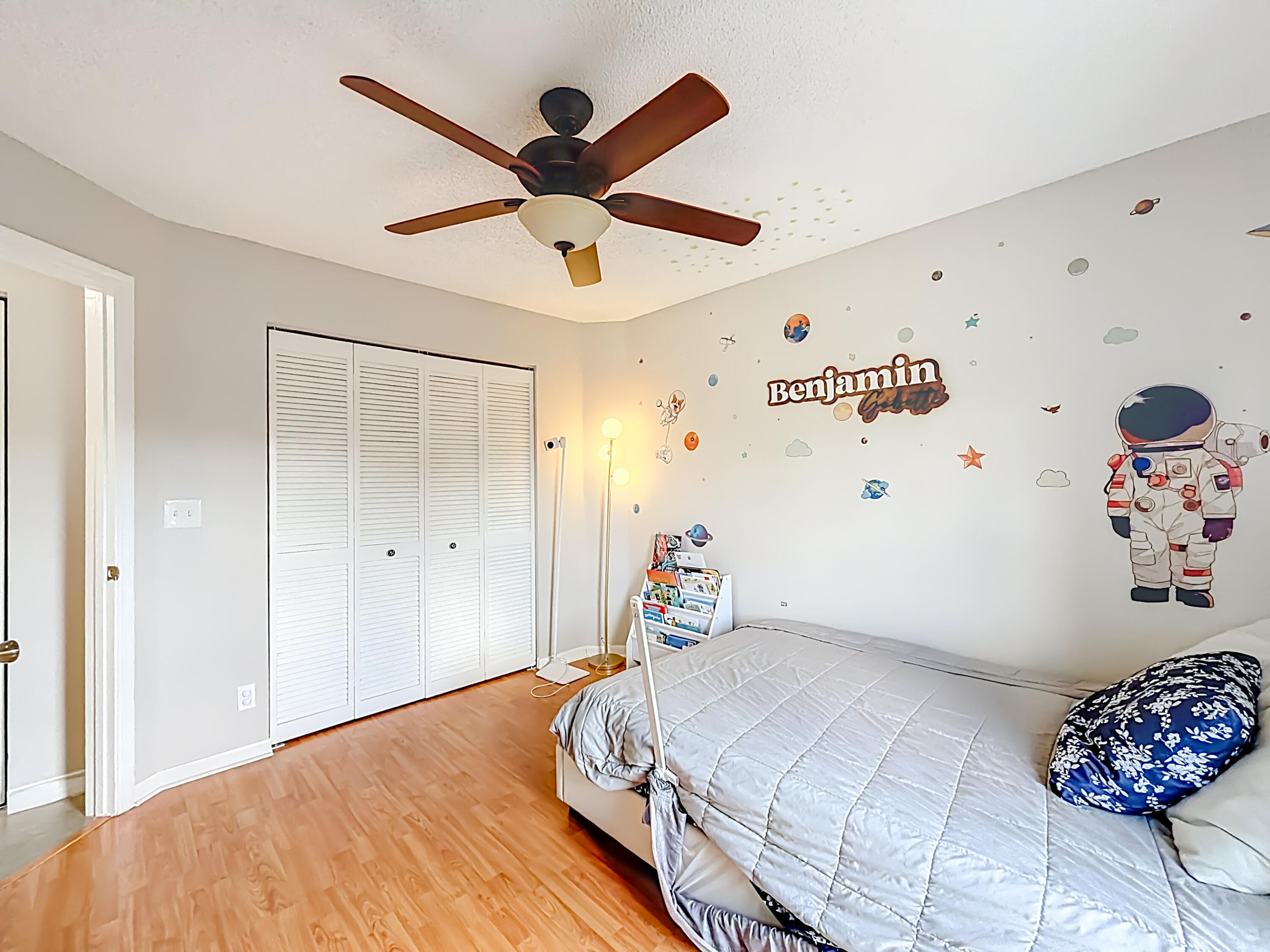 450 Northwest 53rd Street Boca Raton, FL 33487 - Photo 25 of 52 a bedroom with a bed and a chandelier