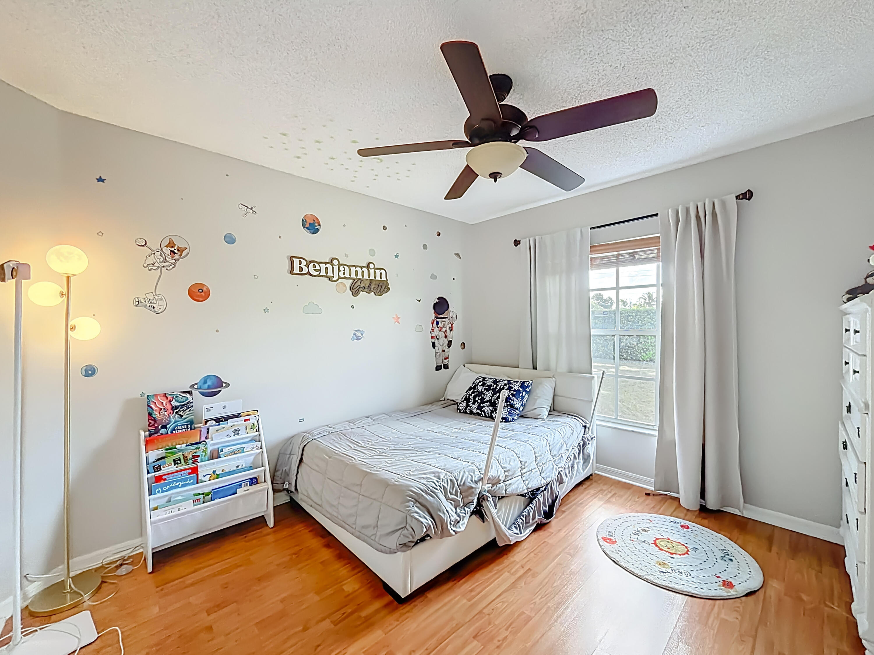 450 Northwest 53rd Street Boca Raton, FL 33487 - Photo 26 of 52 a bedroom with a bed and a chandelier