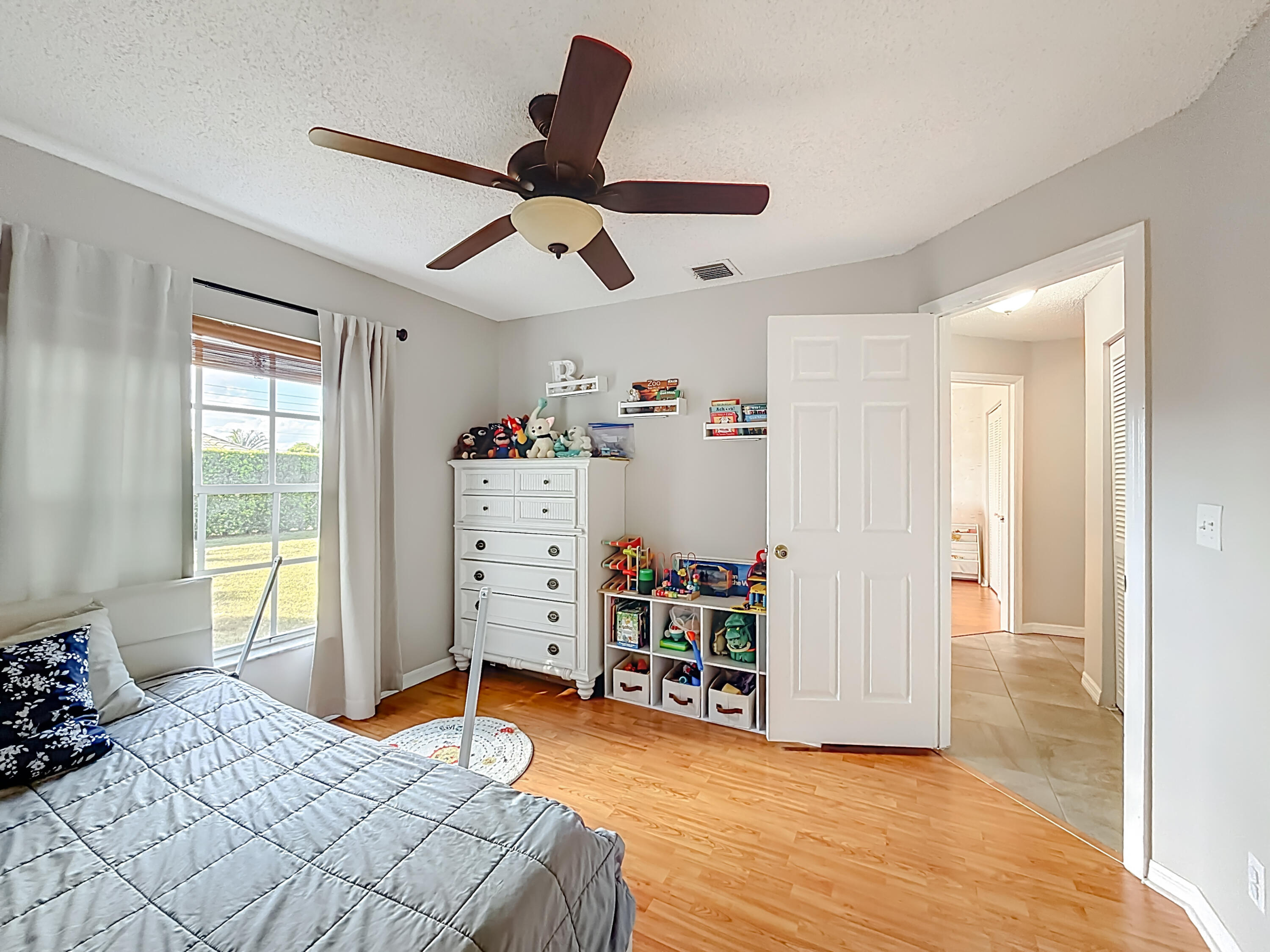 450 Northwest 53rd Street Boca Raton, FL 33487 - Photo 27 of 52 a bedroom with a bed and a large window