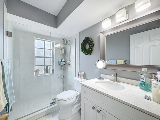 a view of a house with pool fire pit tables and chairs under an umbrella