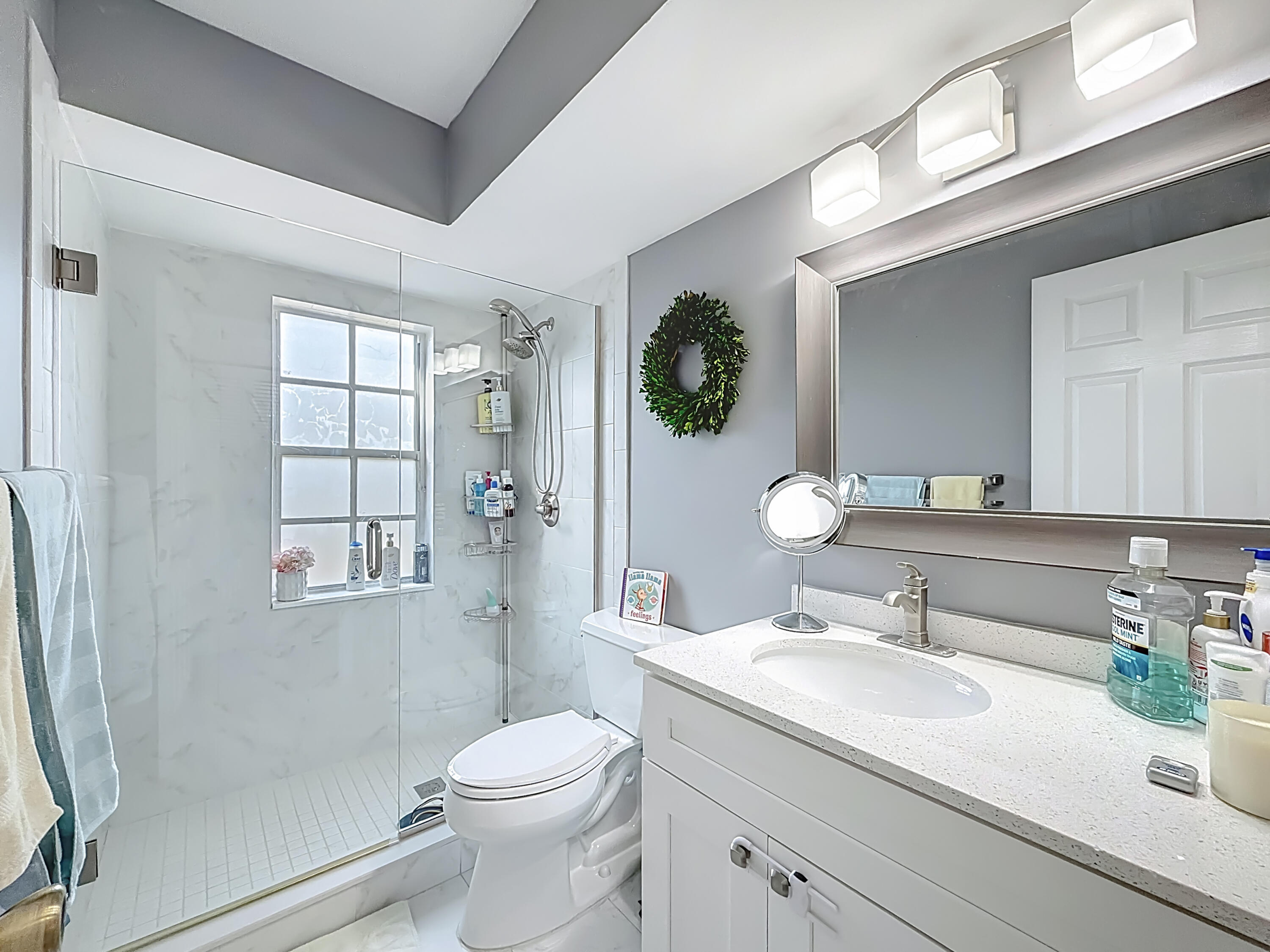 450 Northwest 53rd Street Boca Raton, FL 33487 - Photo 28 of 52 a bathroom with a sink a toilet and shower