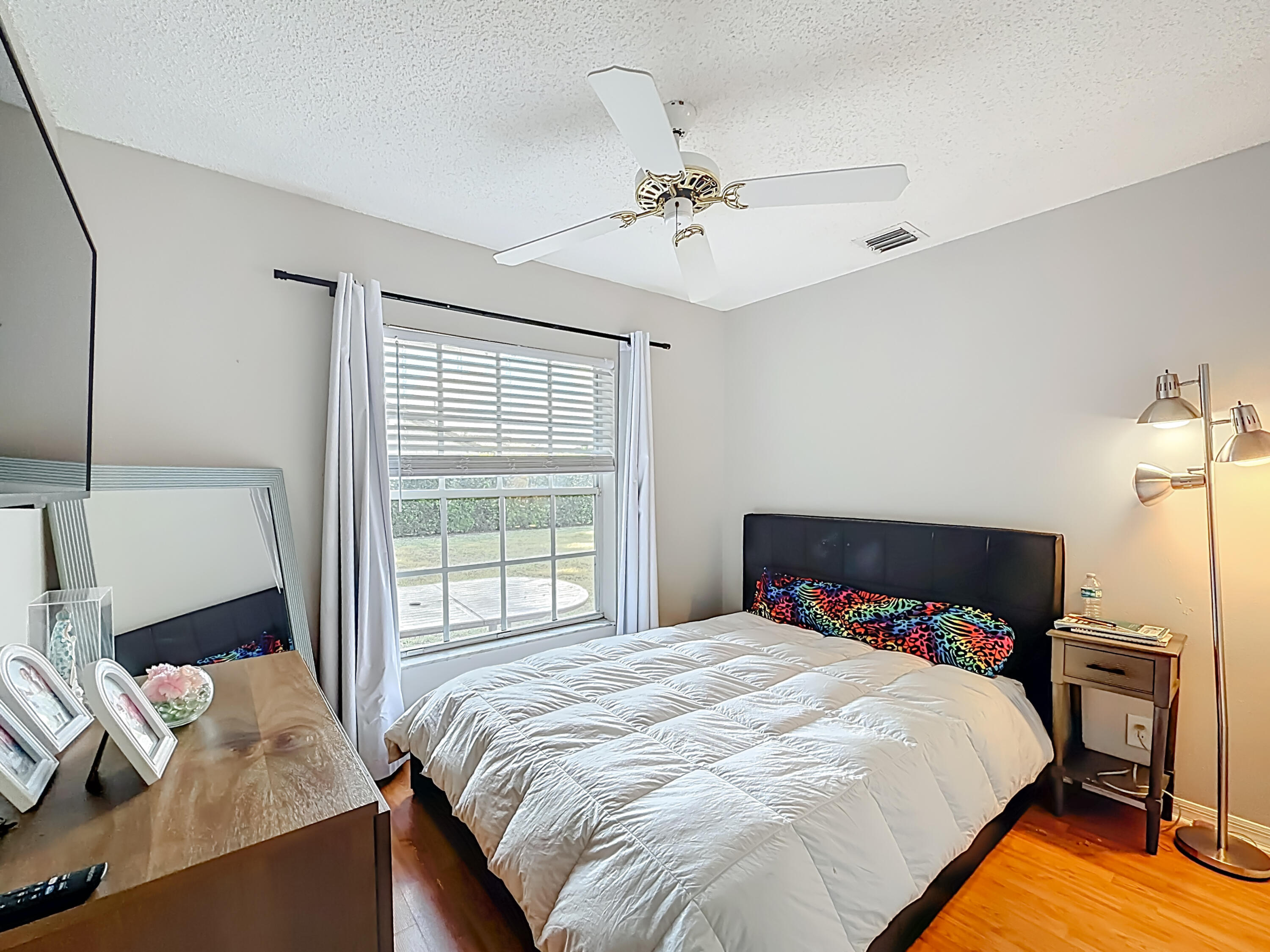 450 Northwest 53rd Street Boca Raton, FL 33487 - Photo 29 of 52 a bedroom with a bed and wooden floor