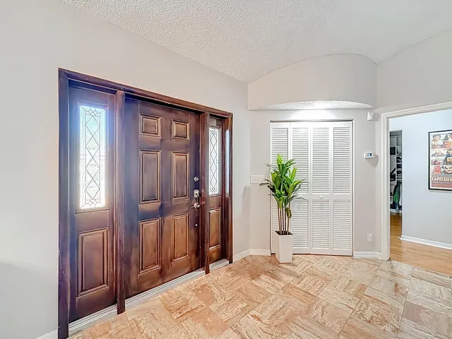 a kitchen with granite countertop white cabinets and stainless steel appliances