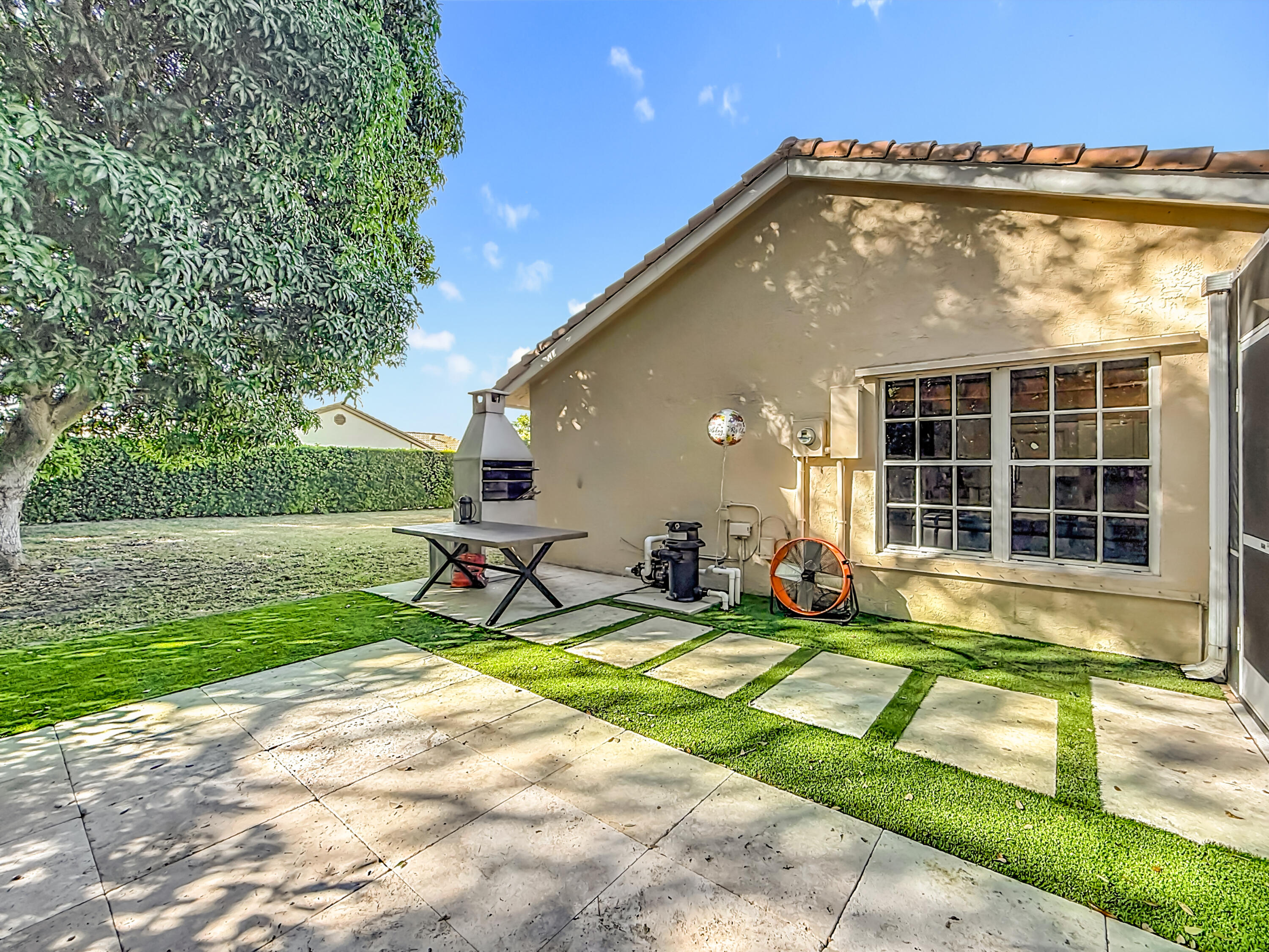 450 Northwest 53rd Street Boca Raton, FL 33487 - Photo 43 of 52 a view of swimming pool with lawn chairs and plants