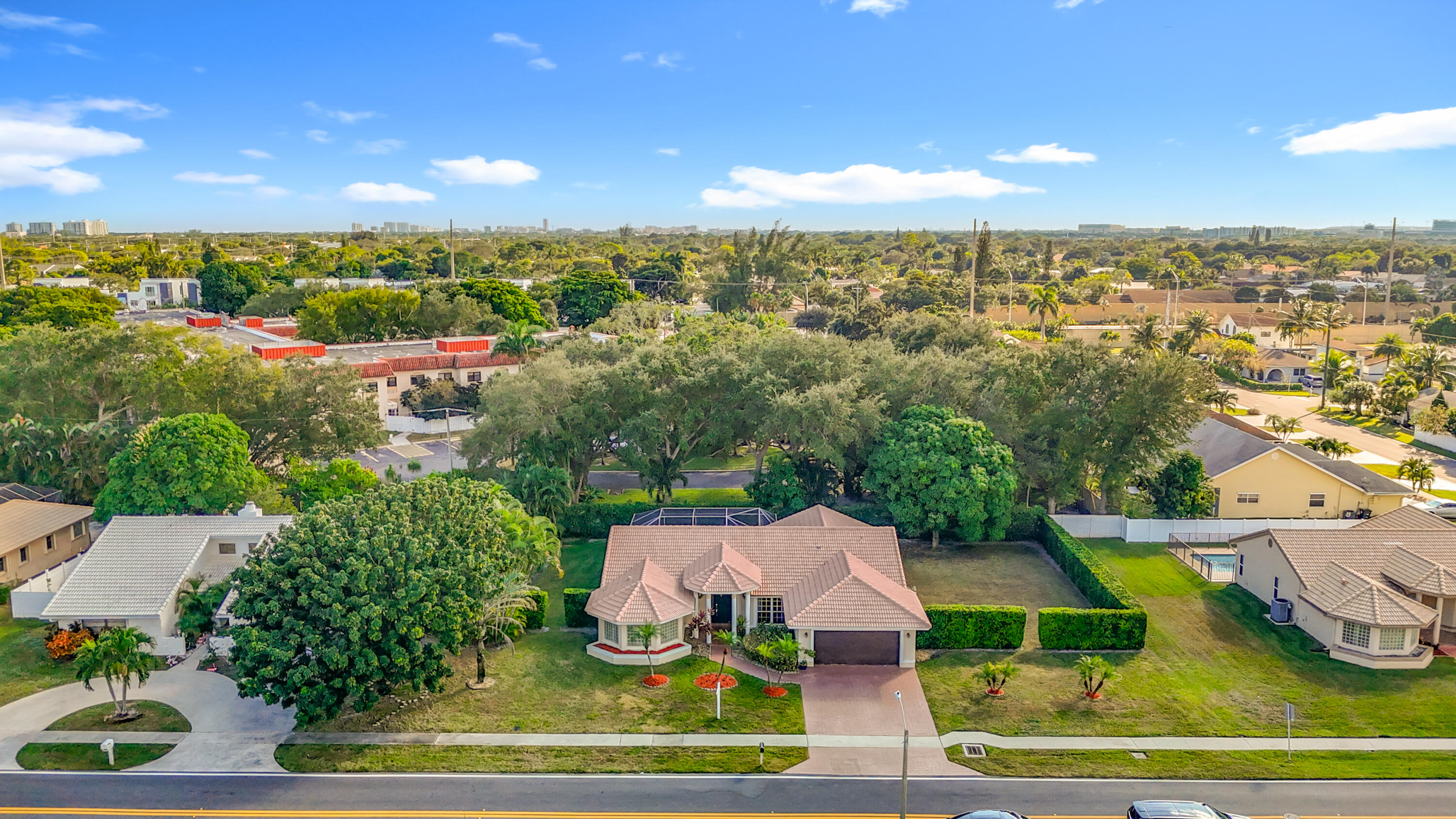450 Northwest 53rd Street Boca Raton, FL 33487 - Photo 47 of 52 an aerial view of residential houses with outdoor space and trees