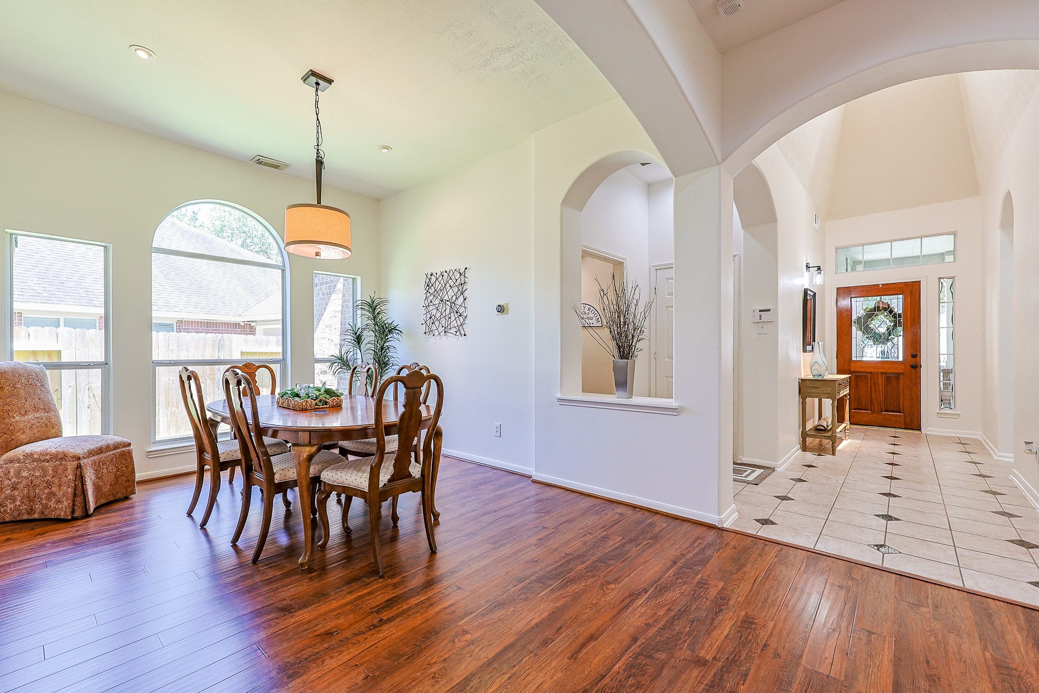 10306 Rudolph Court Missouri City, TX 77459 - Photo 8 of 34 Step into a beautifully designed formal dining space features rich warm-toned wood plank flooring and recessed lighting to highlight your special wall art.