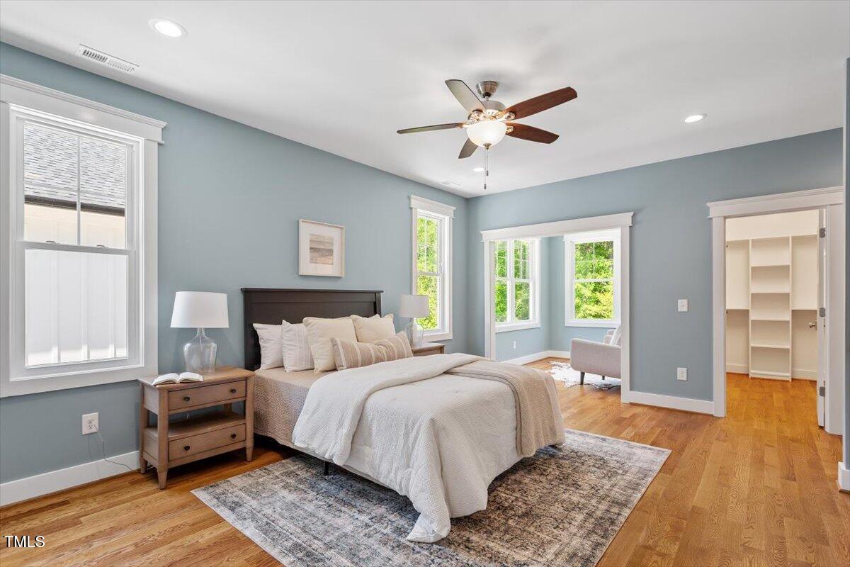 3932 Old Chapel Hill Road Durham, NC 27707 - Photo 6 of 46 a bedroom with a large bed and a chandelier