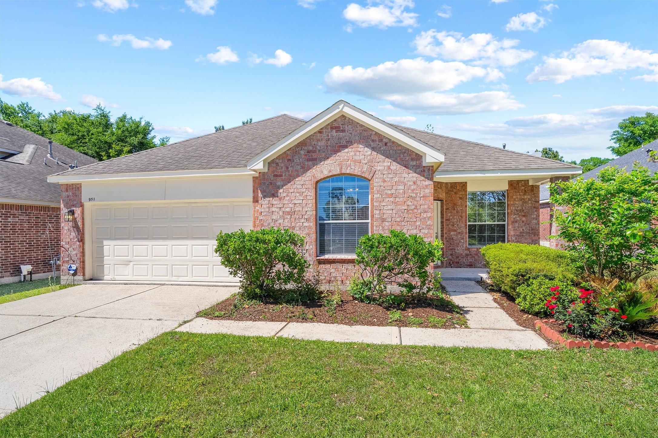 951 Crannog Way Conroe, TX 77301 - Photo 1 of 44 a front view of a house with a yard