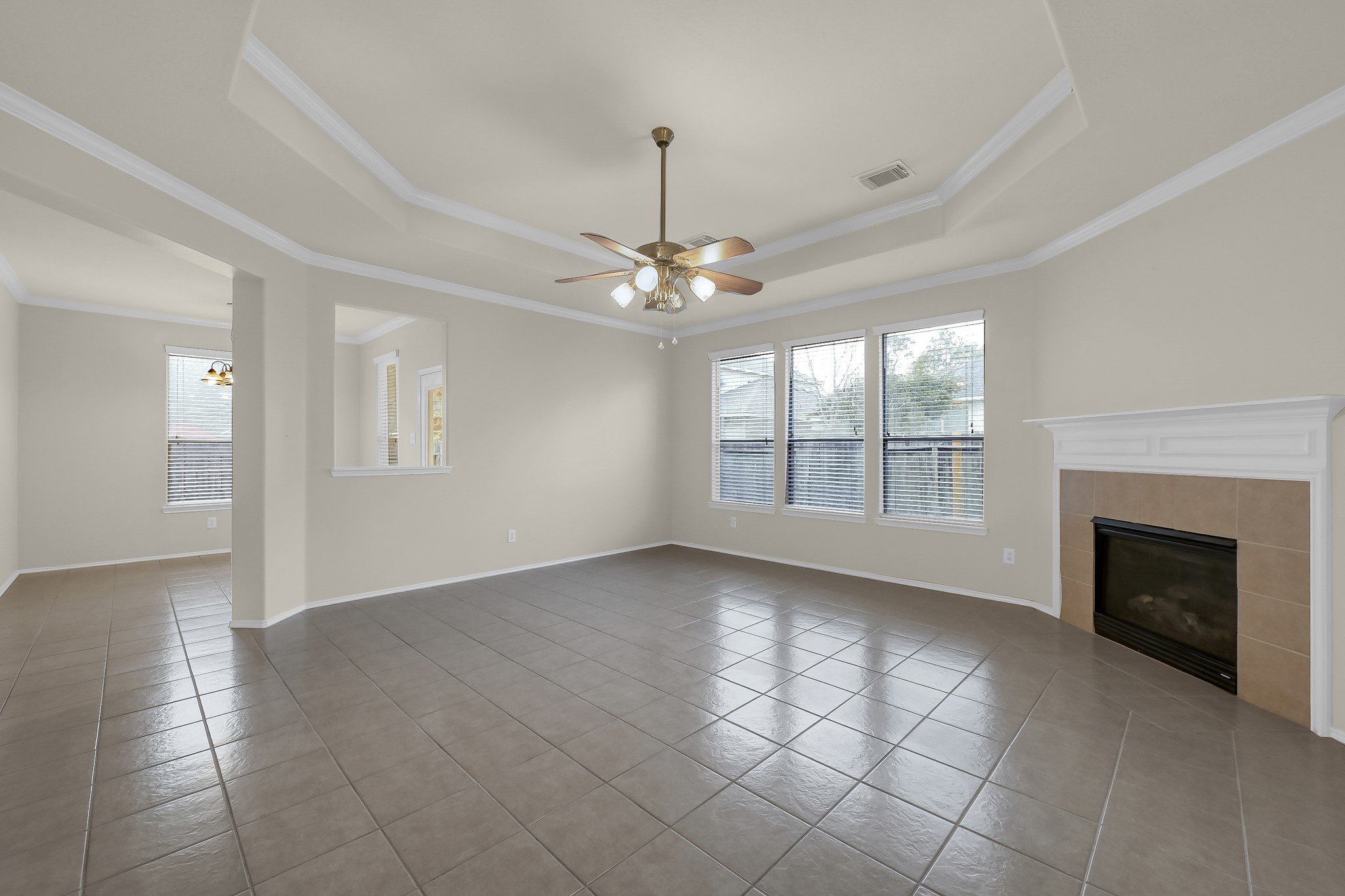 951 Crannog Way Conroe, TX 77301 - Photo 11 of 44 an empty room with windows and fireplace