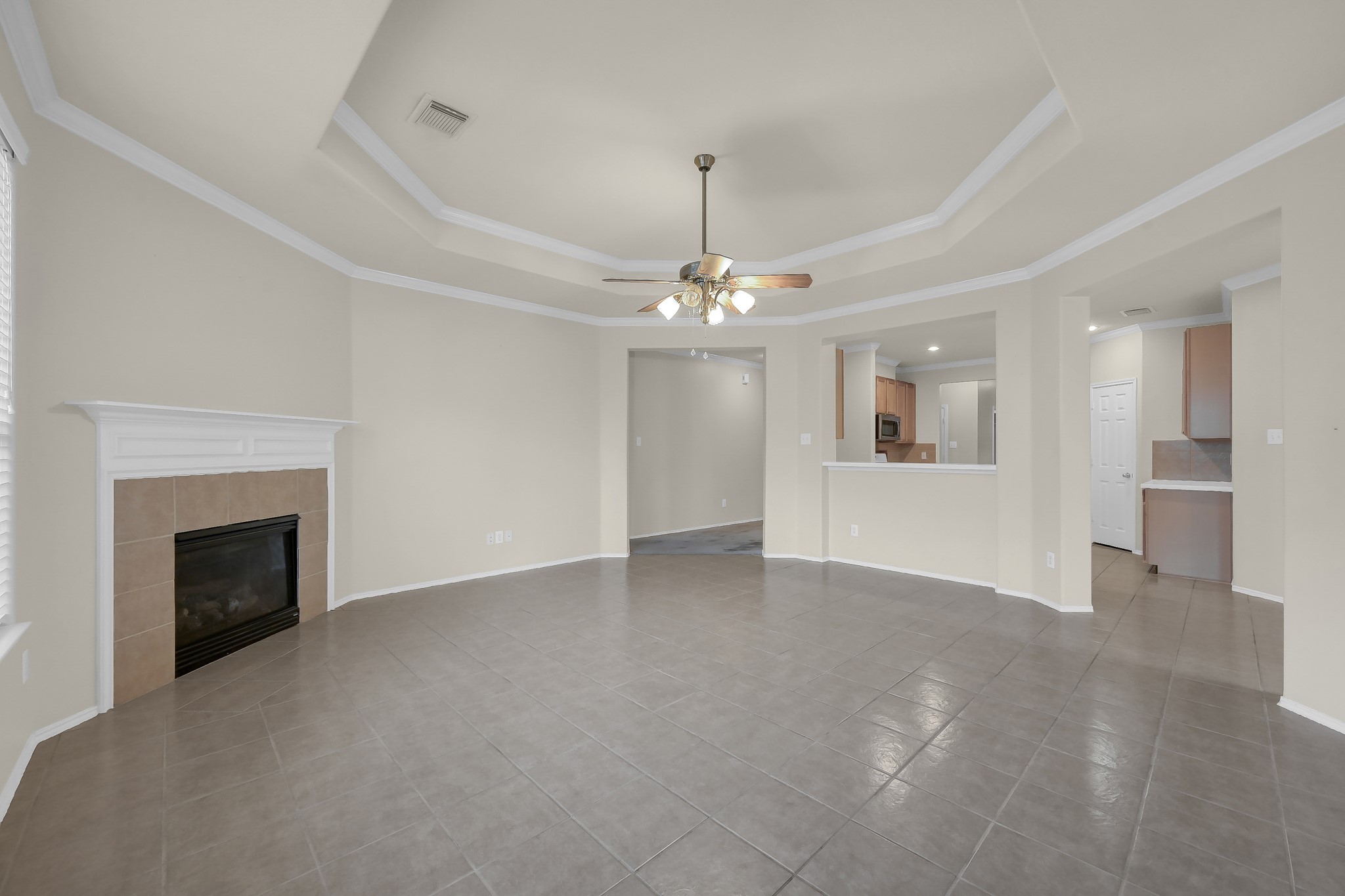951 Crannog Way Conroe, TX 77301 - Photo 13 of 44 a view of a livingroom with a fireplace a chandelier and windows