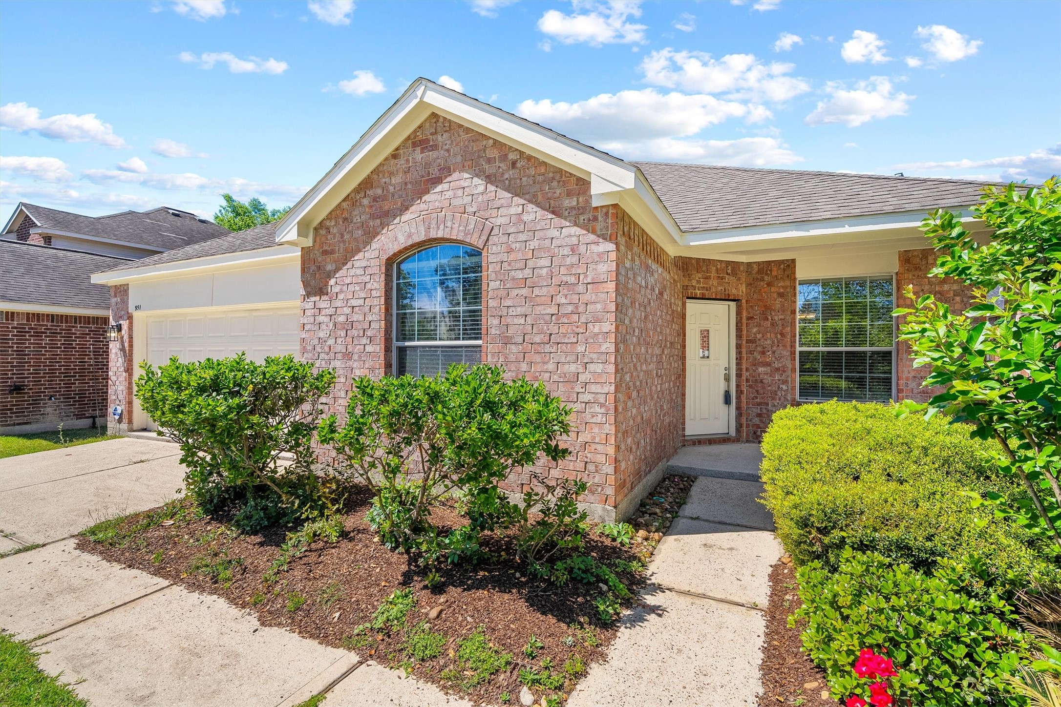 951 Crannog Way Conroe, TX 77301 - Photo 3 of 44 a front view of a house with garden