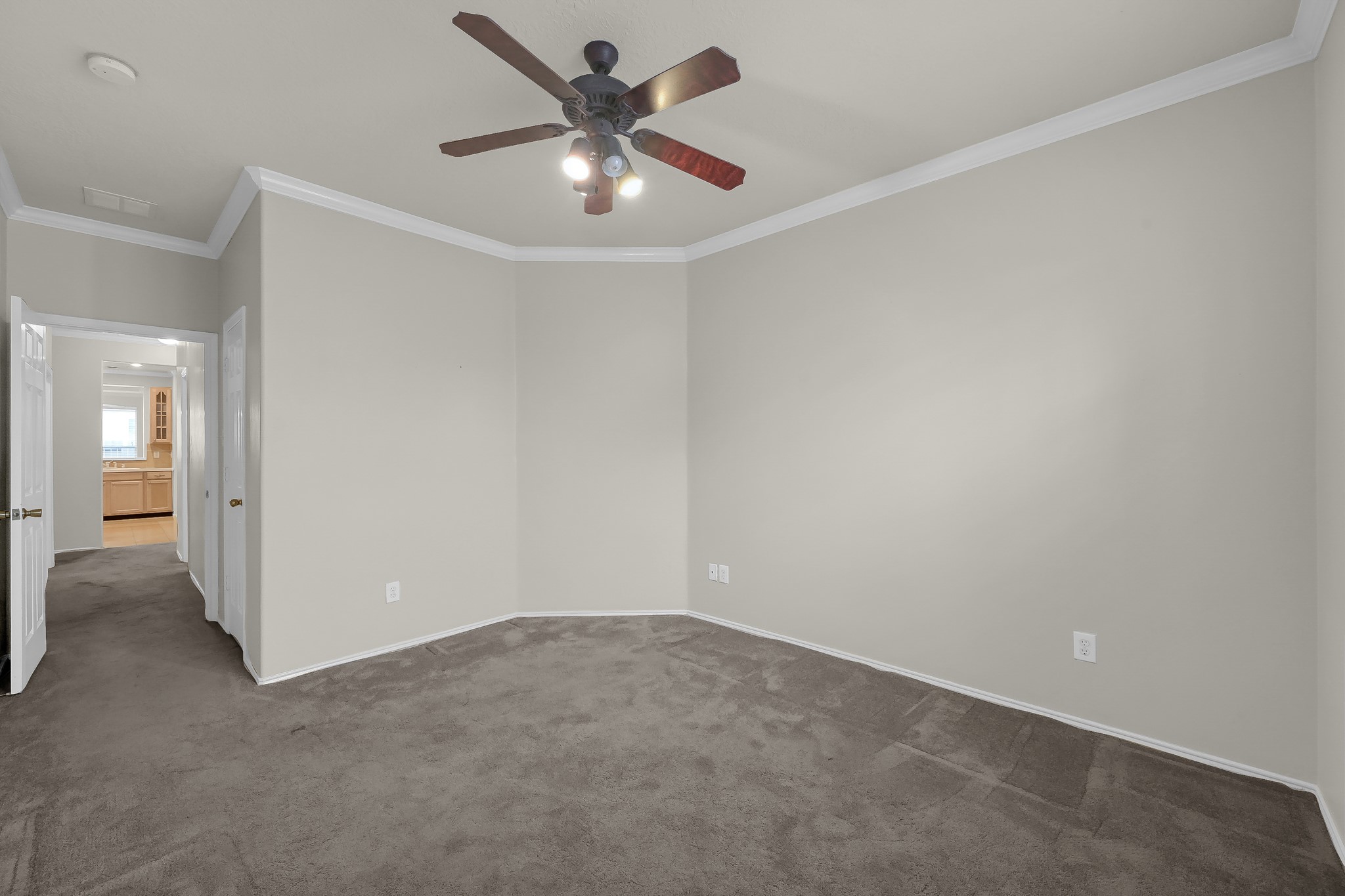951 Crannog Way Conroe, TX 77301 - Photo 34 of 44 an empty room with a chandelier fan and windows