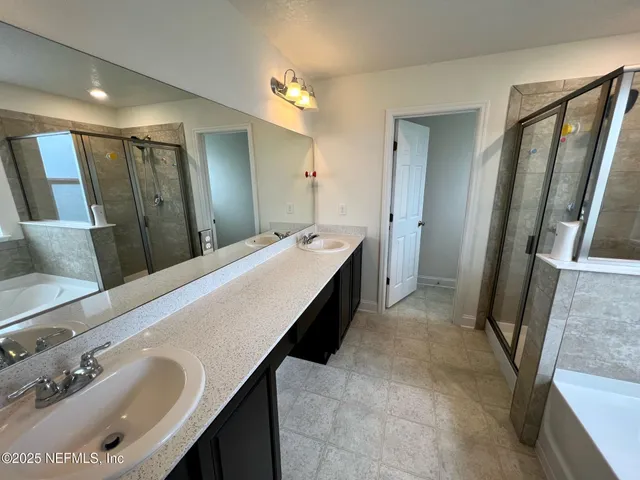 a spacious bathroom with a double vanity sink and a mirror