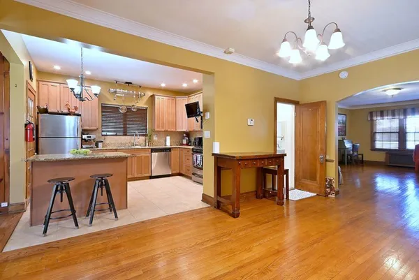 a view of kitchen with dining room and wooden floor