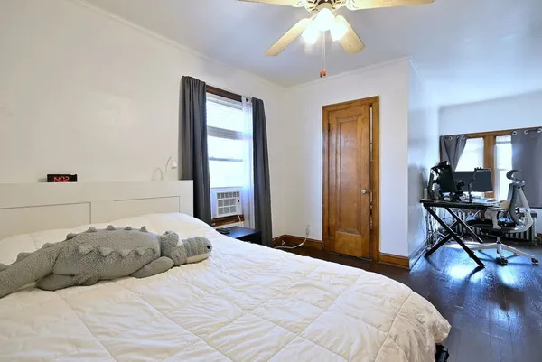 a bedroom with a bed and a chandelier