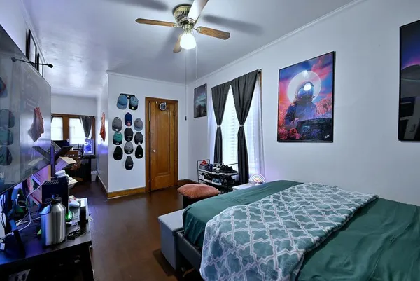 a bedroom with bed and a chandelier