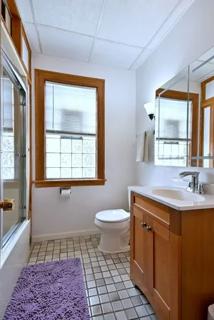 a bathroom with a toilet a sink and a mirror