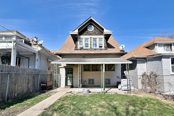 a front view of a house with a yard and table and chairs