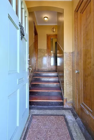 a view of entryway and hall with wooden floor