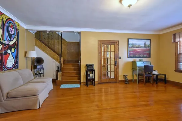 a living room with furniture and wooden floor