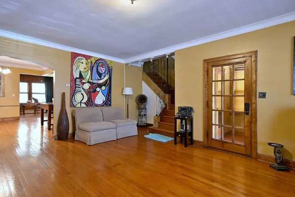 a living room with furniture and wooden floor