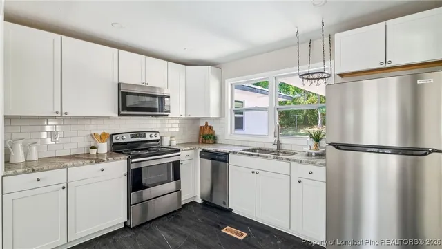 a kitchen with white cabinets sink and white appliances