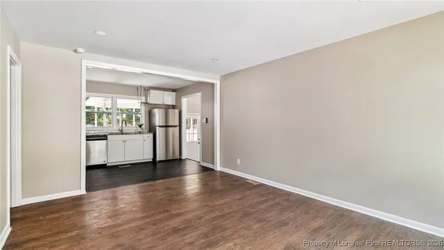 a view of a kitchen with a white cabinet and refrigerator