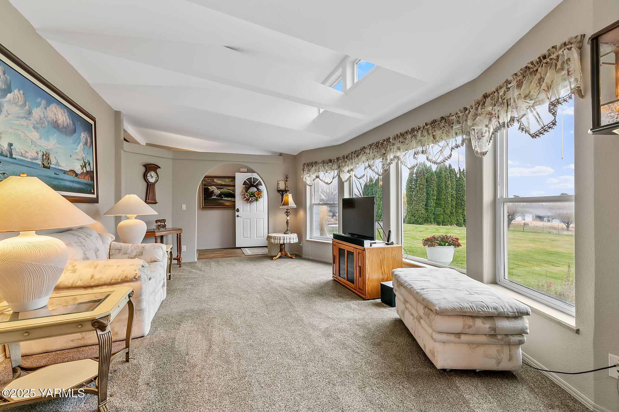 a living room with furniture and large windows