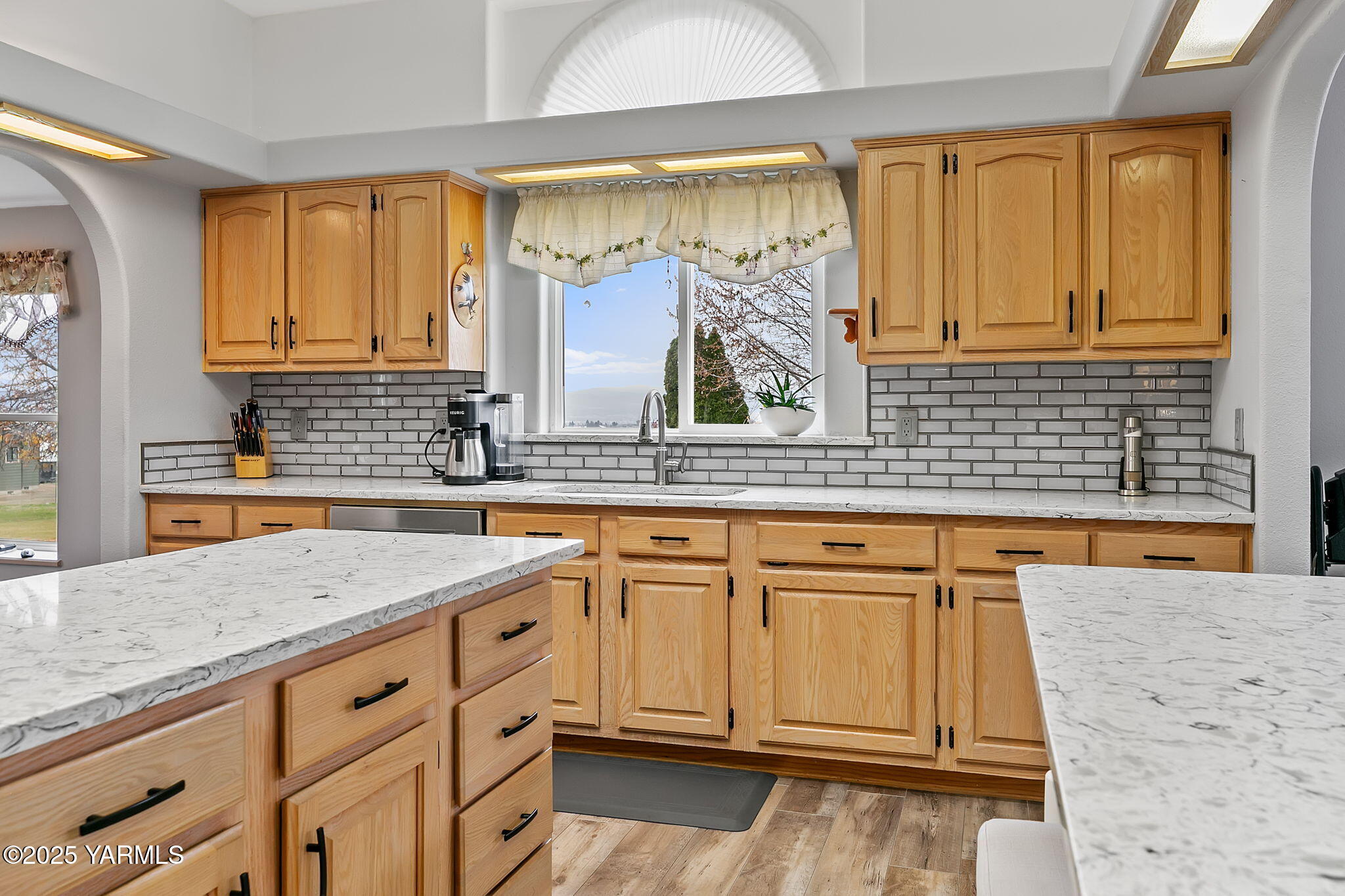 312 Wendt Road Yakima, WA 98901 - Photo 10 of 37 a kitchen with granite countertop white cabinets and white appliances