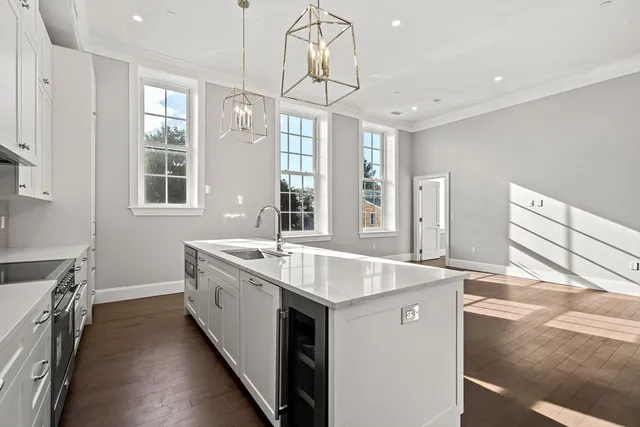 a spacious kitchen with stainless steel appliances granite countertop a sink and dishwasher