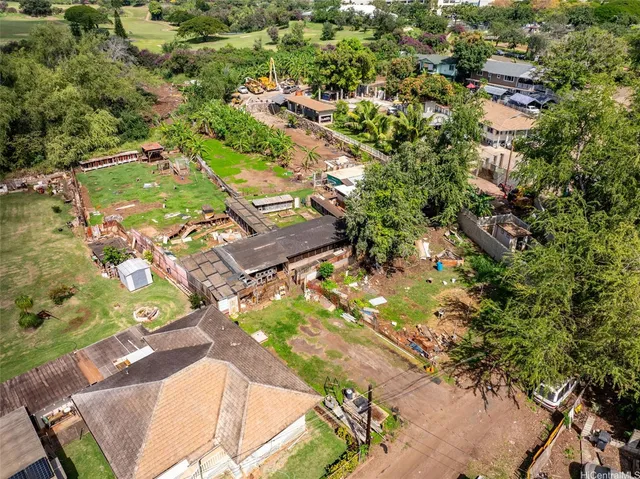 an aerial view of a residential houses with yard