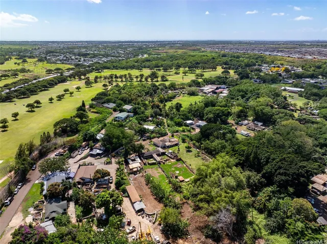 an aerial view of a houses with a yard
