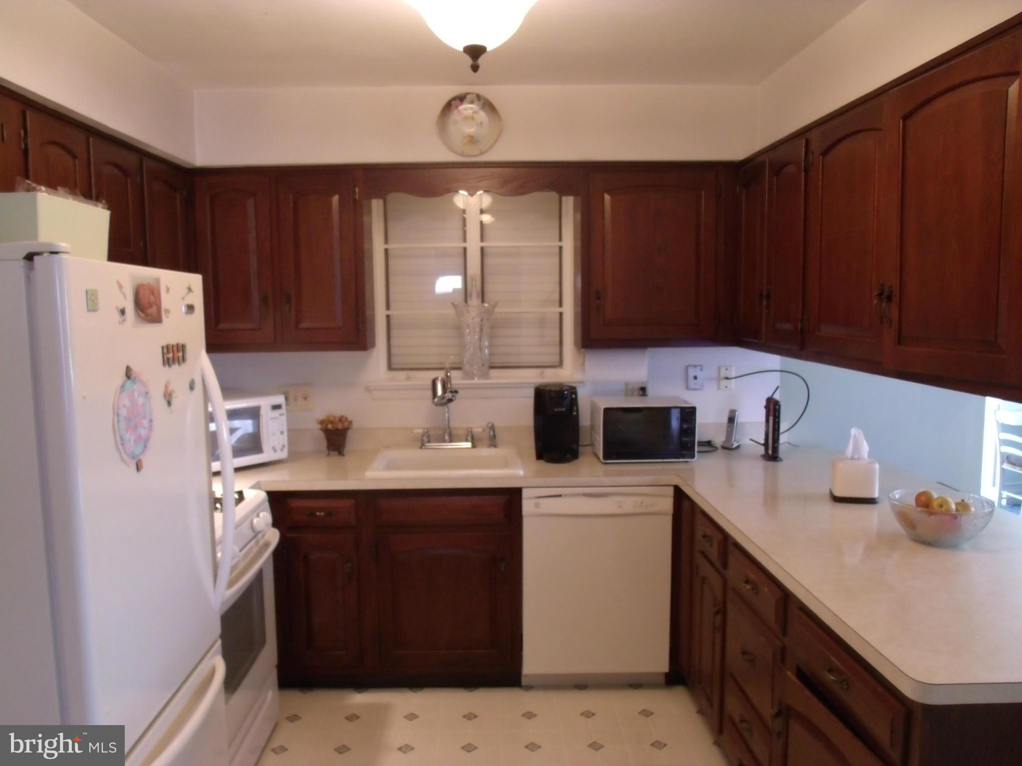 5214 Light Street Springfield, VA 22151 - Photo 13 of 27 a kitchen with a sink a stove a refrigerator and cabinets