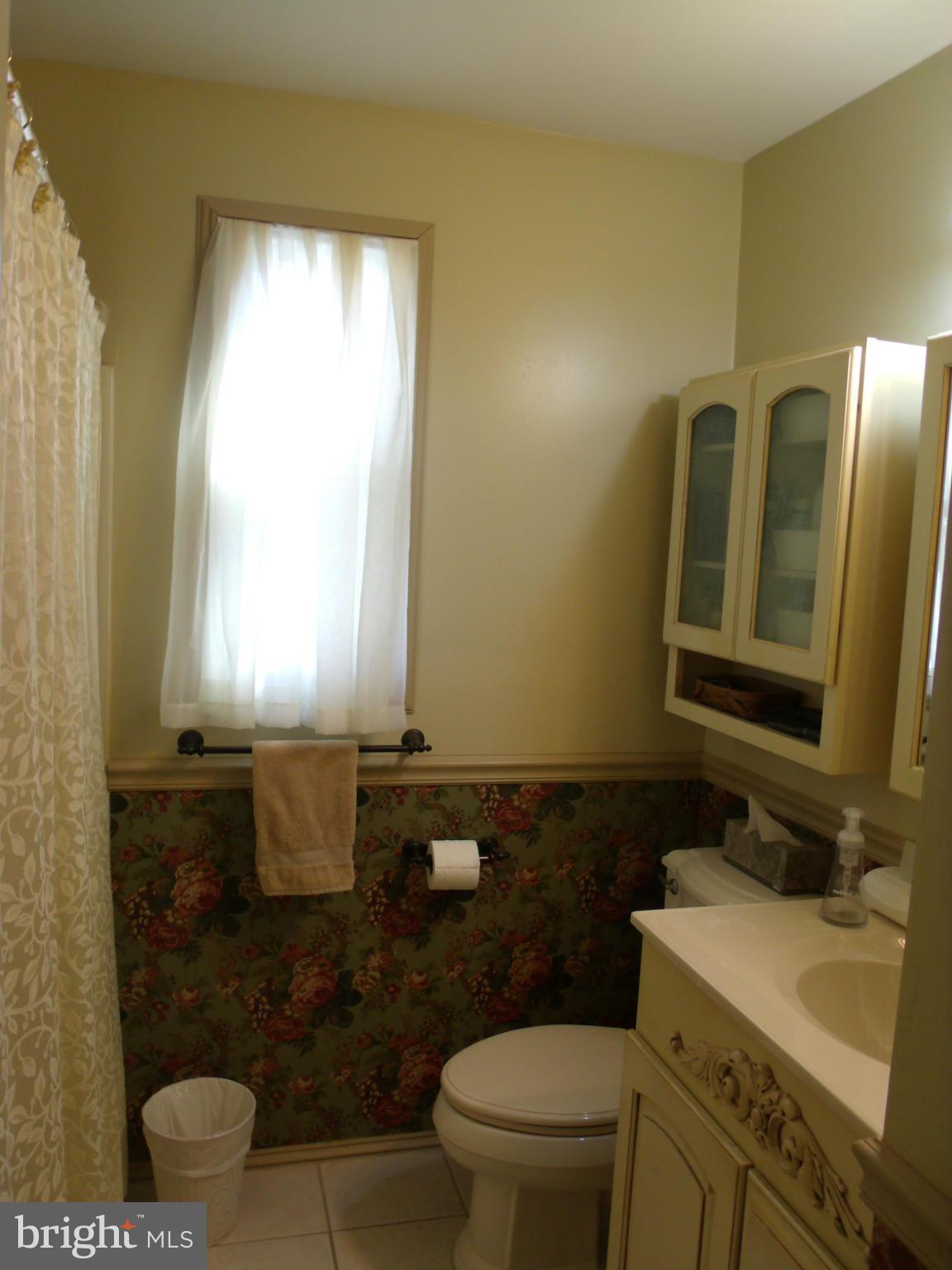 5214 Light Street Springfield, VA 22151 - Photo 17 of 27 a bathroom with a sink toilet and mirror
