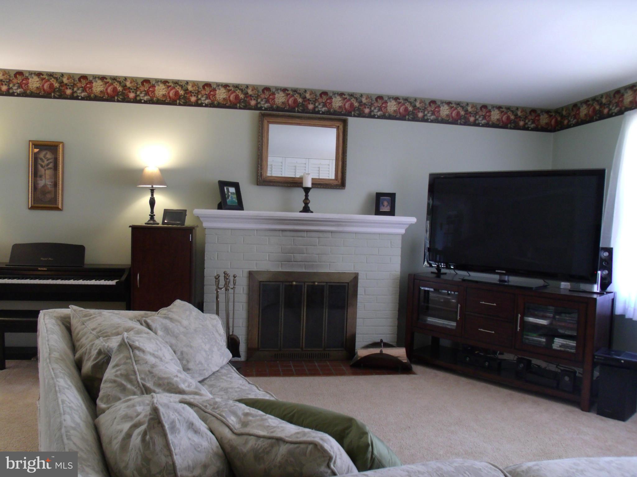 5214 Light Street Springfield, VA 22151 - Photo 5 of 27 a living room with furniture and a flat screen tv
