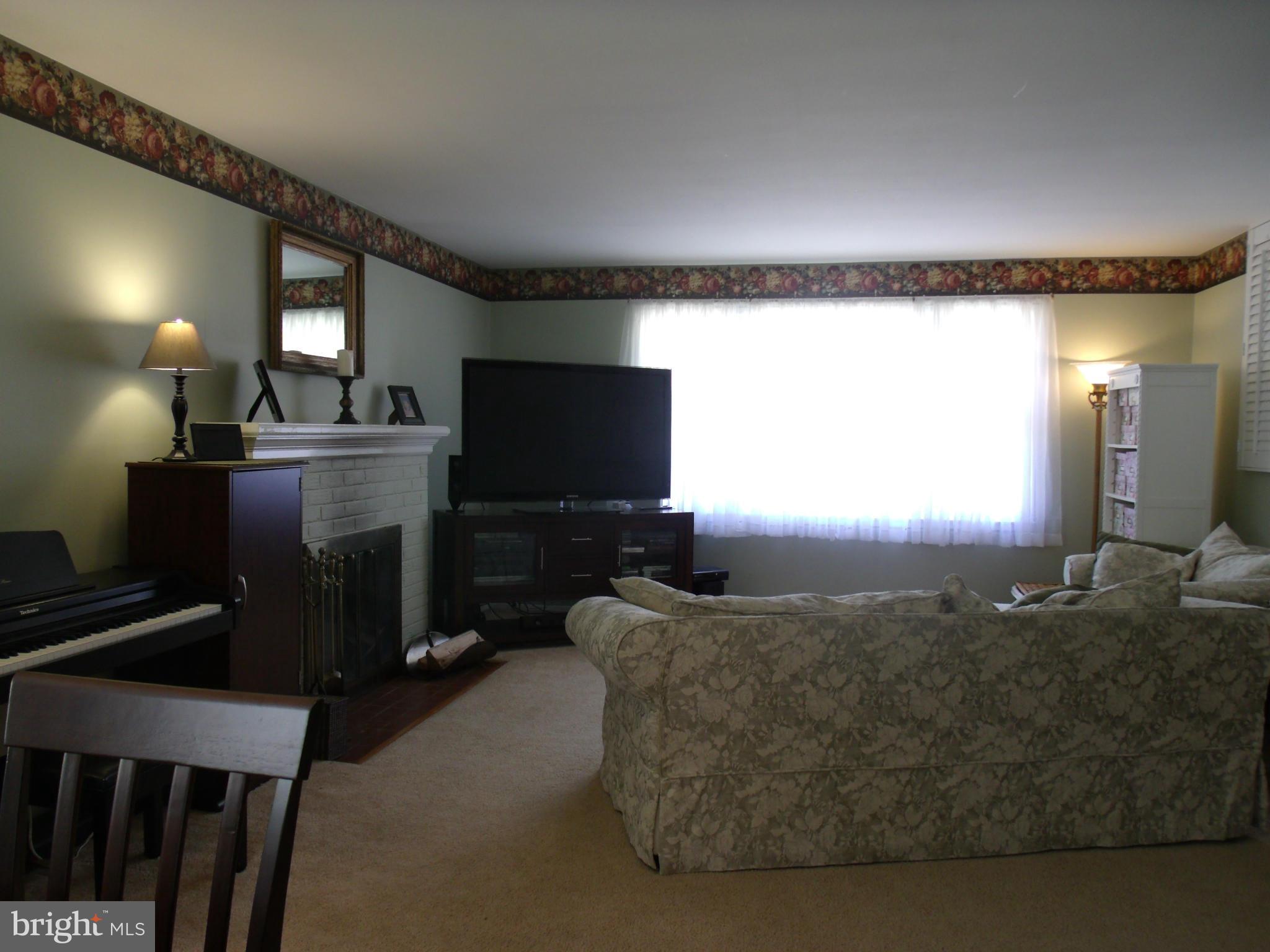 5214 Light Street Springfield, VA 22151 - Photo 6 of 27 a living room with furniture and a flat screen tv