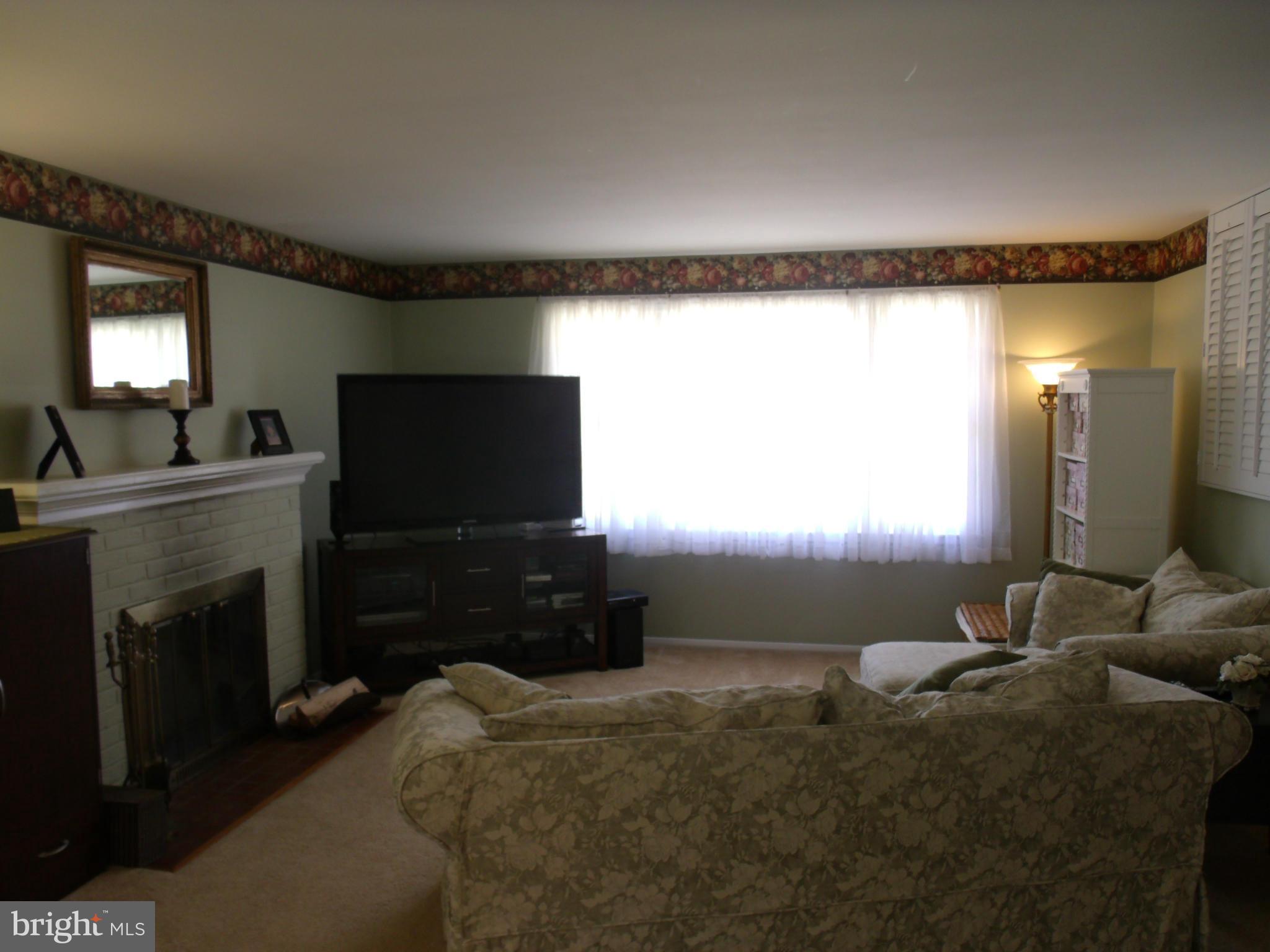 5214 Light Street Springfield, VA 22151 - Photo 7 of 27 a bedroom with furniture and a flat screen tv
