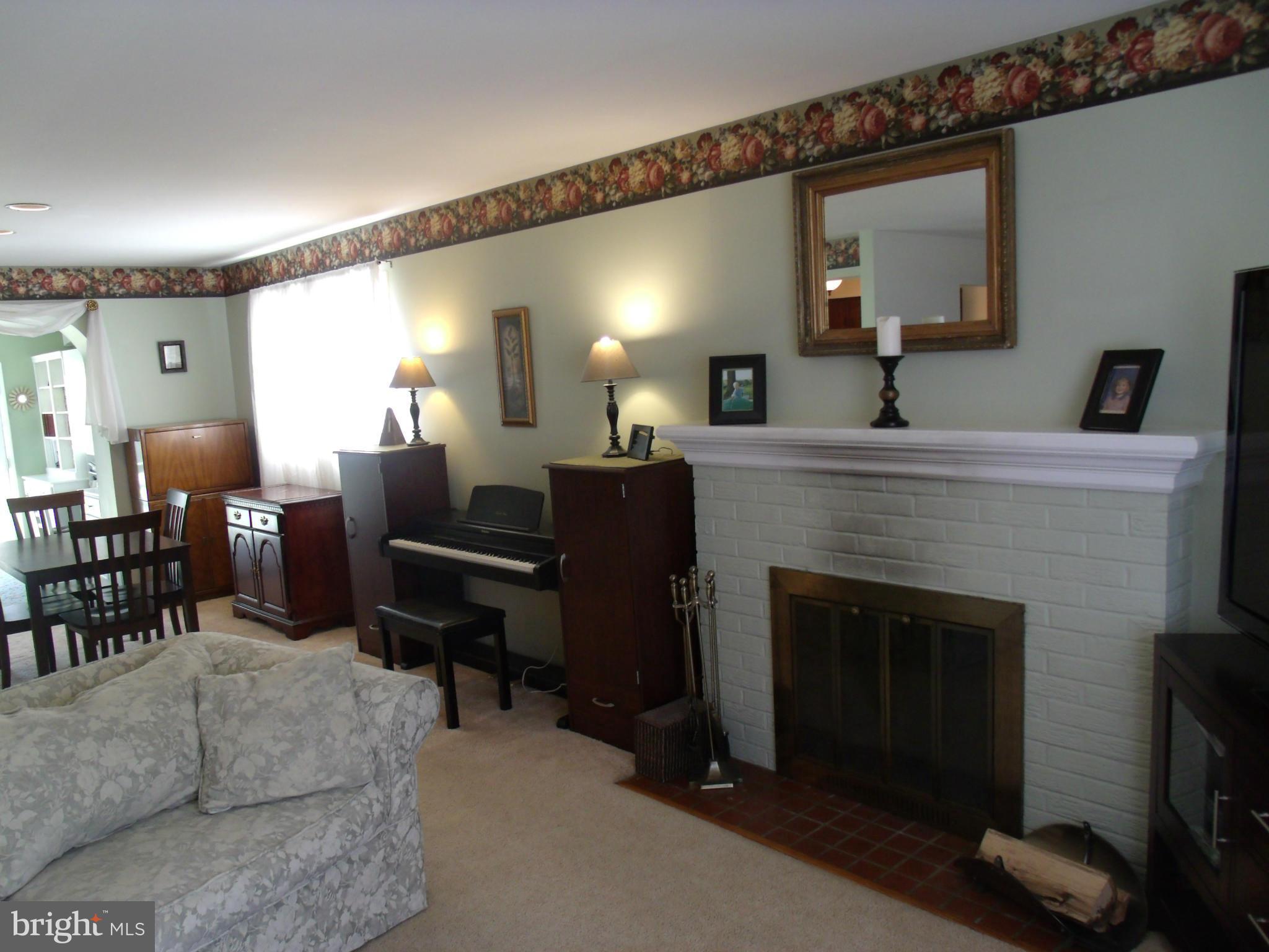 5214 Light Street Springfield, VA 22151 - Photo 8 of 27 a living room with furniture and a fireplace
