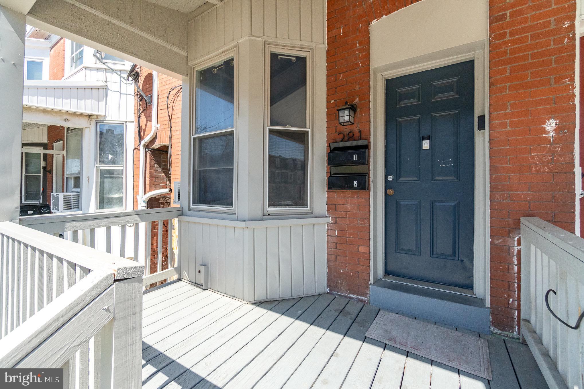a view of a house with a door and wooden floor