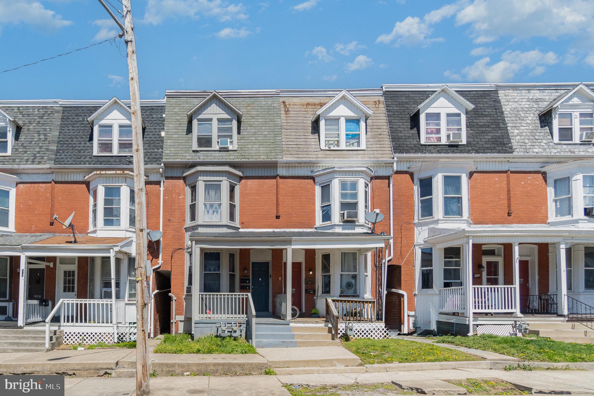 281 West Cottage Place York, PA 17401 - Photo 2 of 30 a front view of a residential apartment building with a yard