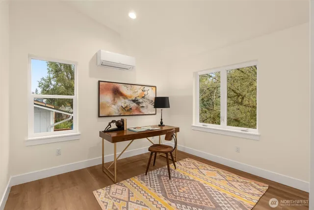 a work room with wooden floor and a window