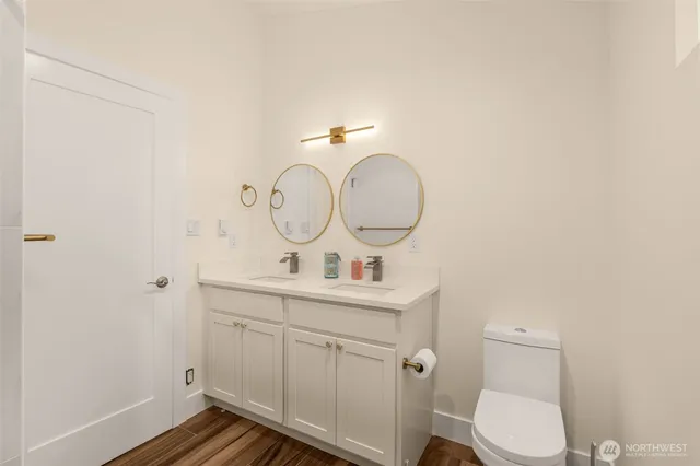 a bathroom with a toilet a sink and mirror